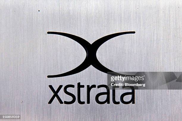 The Xstrata Plc logo sits on a plaque outside the shared building that houses the company's headquarters in Zug, Switzerland, on Friday, Aug. 24,...