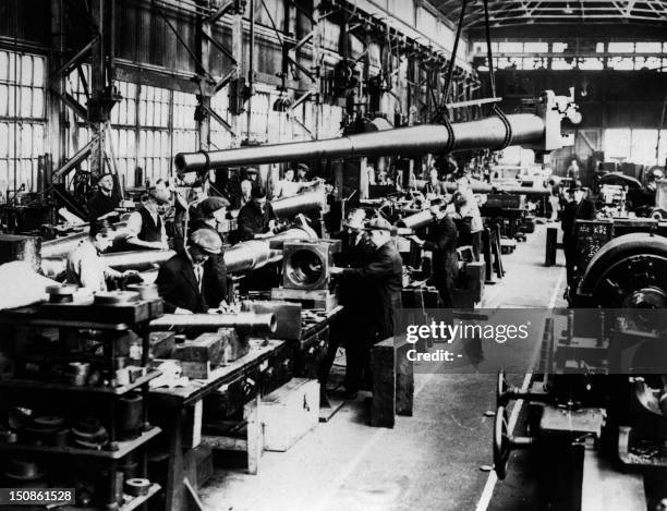 People work in an arms factory in November 1938, somewhere in Great Britain.