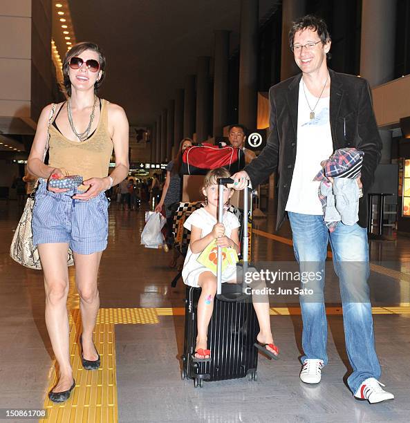 Actress Milla Jovovich, Ever Anderson and producer Paul W. S. Anderson arrive at Narita International Airport on August 28, 2012 in Narita, Japan.