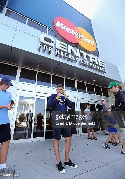 Alex Galchenyuk of the Montreal Canadiens speaks on the phone following a media opportunity at the 2012 NHLPA rookie showcase at the MasterCard...