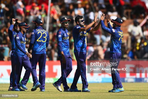 Mahesh Theekshana of Sri Lanka celebrates with teammate Dhananjaya de Silva after dismissing Sean Williams of Zimbabwe during the ICC Men's Cricket...