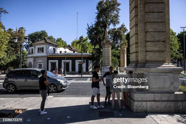 Pedestrians wait in the shade during high temperatures on Espana square in Seville, Spain, on Wednesday, July 5, 2023. Global temperatures hit a...