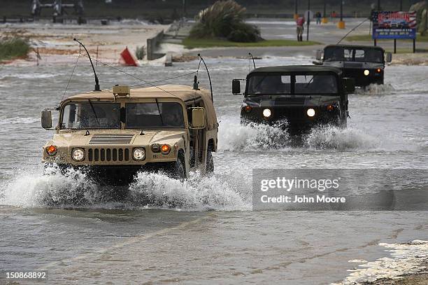 National Guard patrol passes along a flooded beach ahead of the arrival of Hurricane Isaac on August 28, 2012 in Waveland, Mississippi. Many...