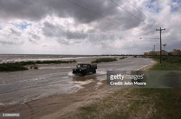 National Guard patrol passes along a flooded beach ahead of the arrival of Hurricane Isaac on August 28, 2012 in Waveland, Mississippi. Many...