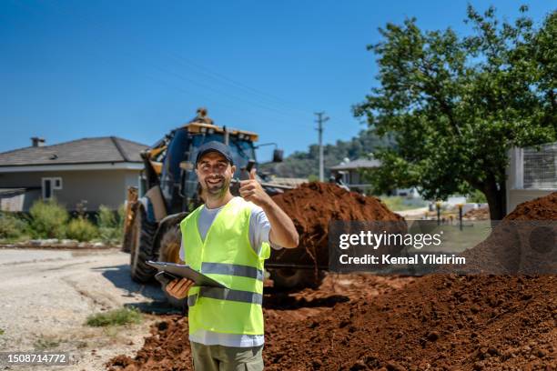 landscape gardener filling garden with new soil - landscape architect stock pictures, royalty-free photos & images