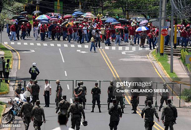 Soldiers and policemen block the passage to a march of workers and users of the state-owned Empresa Nacional de Energia Electrica , demanding to the...