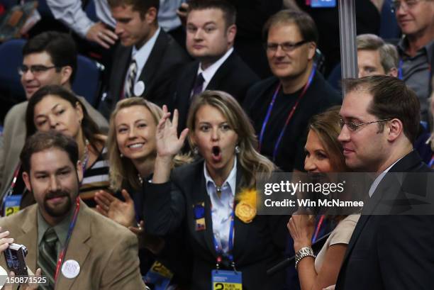 Minnesota delegates react as they see U.S. Rep. Michele Bachmann on the floor during the Republican National Convention at the Tampa Bay Times Forum...