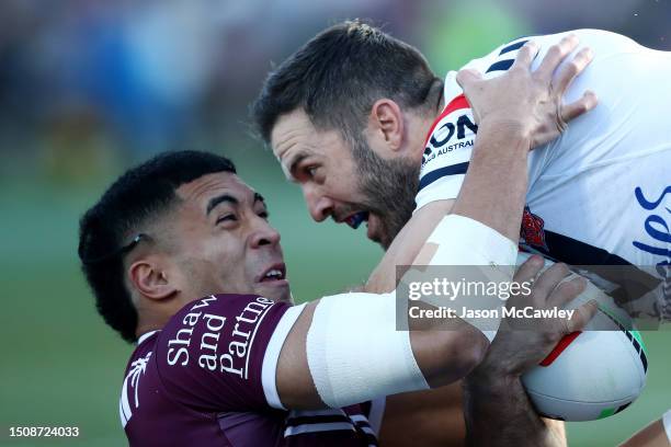 James Tedesco of the Roosters is tackled by Tolutau Koula of the Sea Eagles during the round 18 NRL match between Manly Sea Eagles and Sydney...