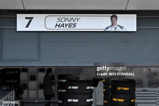 Plate bearing an image of US actor Brad Pitt, playing Sonny Hayes, the driver of the fictional Apex team in an F1-inspired movie, hangs above his...