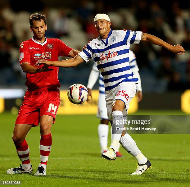 Bobby Zamora of QPR in action with Ben Purkiss of Walsall during the Capital One Cup Second Round match between Queens Park Rangers and Walsall at...