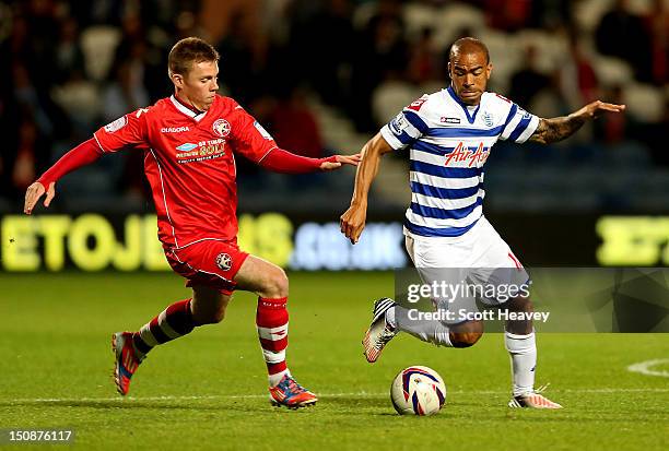 Kieron Dyer of QPR in action with Jake Jones of Walsall during the Capital One Cup Second Round match between Queens Park Rangers and Walsall at...