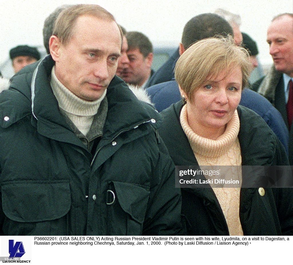 Acting President Vladimir Putin walks with his wife Lyudmila
