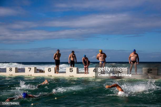 Swimmers take part in a winter swimming competition held by Merewether Mackerels swimming club at Merewether Ocean Baths on July 02, 2023 in...