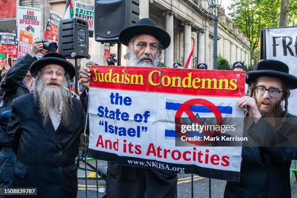 Members of Neturei Karta, a group of Orthodox Haredi Jews opposed to the state of Israel, are pictured protesting with pro-Palestinian activists...