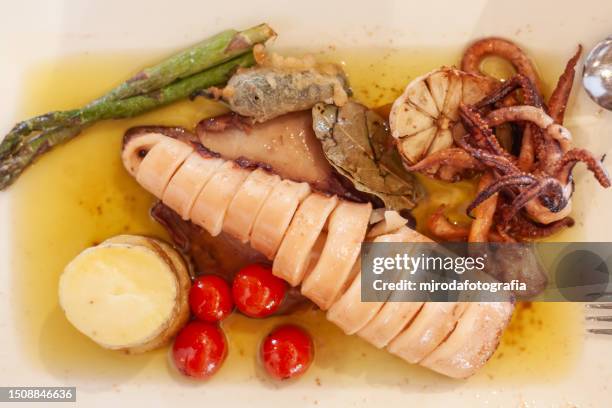 squid in olive oil. typical squid dish from the coast of almeria. andalusia, spain. - almeria restaurant stock-fotos und bilder