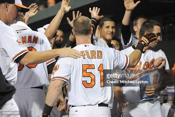 Lew Ford of the Baltimore Orioles celebrates a solo home run in the third inning during a baseball game against the Chicago White Sox on August 28,...