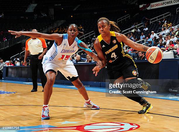 Amber Holt of the Tulsa Shock drives against Tiffany Hayes of the Atlanta Dream at Philips Arena on August 28, 2012 in Atlanta, Georgia. NOTE TO...