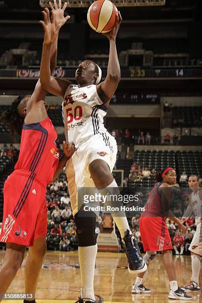 Jessica Davenport of the Indiana Fever shoots over Ashley Robinson of the Washington Mystics at Banker Life Fieldhouse on August 28, 2012 in...