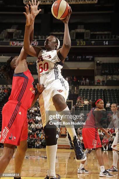 Jessica Davenport of the Indiana Fever shoots over Ashley Robinson of the Washington Mystics at Banker Life Fieldhouse on August 28, 2012 in...