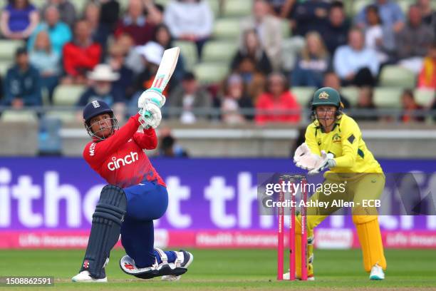 Sophia Dunkley of England hits four as Alyssa Healy of Australia keeps wicket during the Women's Ashes 1st Vitality IT20 match between England and...