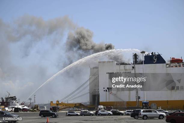 Firefighters respond a fire on a ship docked at Port Newark, New Jersey, United States on July 6, 2023. Two Newark firefighters died and five were...