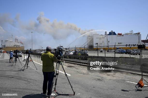 Firefighters respond a fire on a ship docked at Port Newark, New Jersey, United States on July 6, 2023. Two Newark firefighters died and five were...