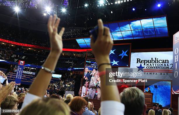 People watch as former U.S. Sen. Rick Santorum speaks during the Republican National Convention at the Tampa Bay Times Forum on August 28, 2012 in...