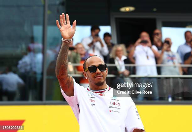 Lewis Hamilton of Great Britain and Mercedes waves to the crowd on the drivers parade prior to the F1 Grand Prix of Austria at Red Bull Ring on July...