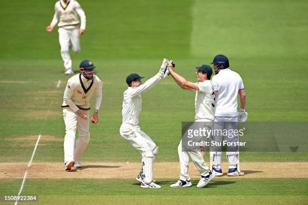 Australia wicketkeeper Alex Carey and Pat Cummins celebrate after running out England batsman Jonny Bairstow during the 5th day of the LV=Insurance...