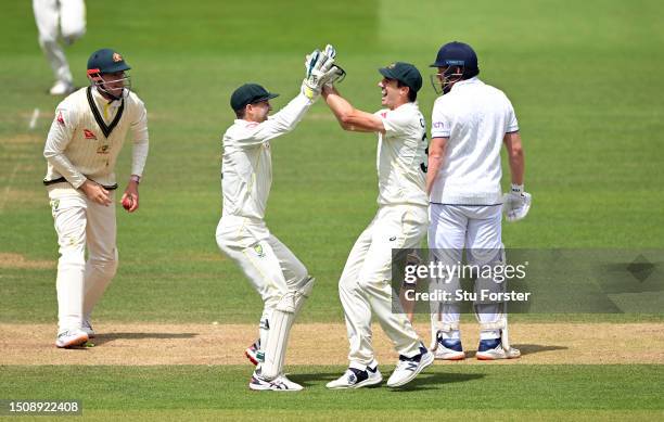 Australia wicketkeeper Alex Carey and Pat Cummins celebrate after running out England batsman Jonny Bairstow during the 5th day of the LV=Insurance...