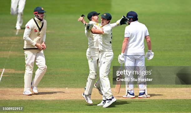 Australia wicketkeeper Alex Carey and Pat Cummins celebrate after running out England batsman Jonny Bairstow during the 5th day of the LV=Insurance...