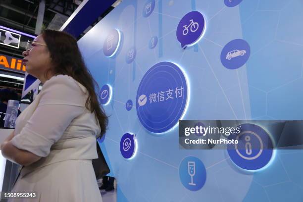 Visitors look at the wechat Pay booth at the 2023 World Artificial Intelligence Conference in Shanghai, China, July 6, 2023.