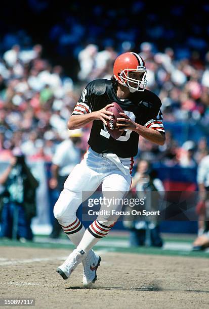 Quarterback Bernie Kosar of the Cleveland Brown drops back to pass against the Dallas Cowboys during an NFL football game at Cleveland Municipal...