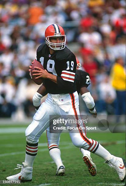 Quarterback Bernie Kosar of the Cleveland Brown drops back to pass against the Washington Redskins during an NFL football game at RFK Stadium October...