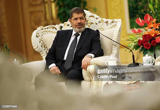 Egyptian President Mohamed Morsi speaks to Chinese Vice-President Xi Jinping during their meeting in the Great Hall of the People on August 29, 2012...