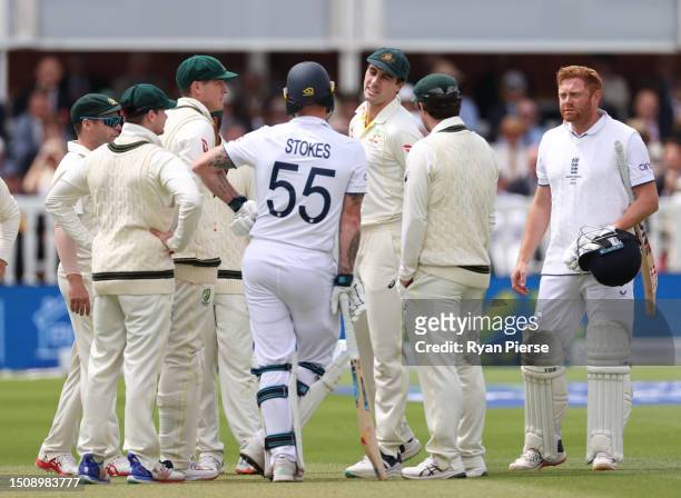 Pat Cummins of Australia speaks with Ben Stokes of England after Jonny Bairstow of England was run out by Alex Carey of Australia during Day Five of...