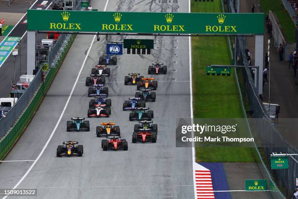 Max Verstappen of the Netherlands driving the Oracle Red Bull Racing RB19 leads the field into turn one at the start during the F1 Grand Prix of...