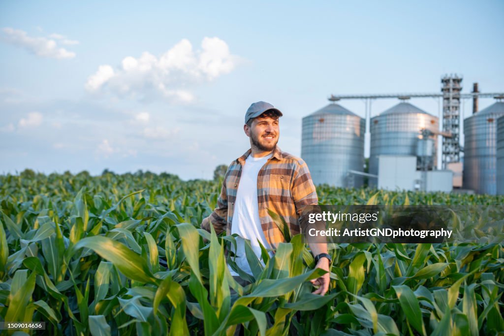 Shot of farmer enjoying the growth of his corn crops.