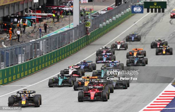Max Verstappen of the Netherlands driving the Oracle Red Bull Racing RB19 leads Charles Leclerc of Monaco driving the Ferrari SF-23 and the rest of...