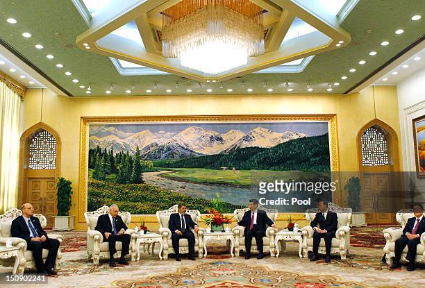 Egyptian President Mohamed Morsi chats with Chinese Vice-President Xi Jinping while their officials look on during their meeting in the Great Hall of...