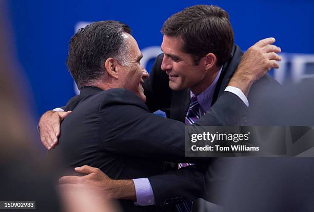 Mitt Romney, republican presidential nominee, hugs his son Matt, after the elder's wife Ann Romney, delivered a speech on the floor of the Republican...