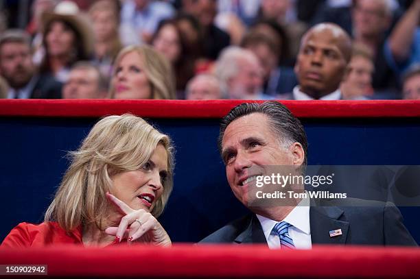 Mitt Romney, republican presidential nominee, talks with his wife Ann, after she delivered a speech on the floor of the Republican National...