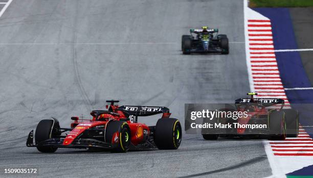 Charles Leclerc of Monaco driving the Ferrari SF-23 leads Carlos Sainz of Spain driving the Ferrari SF-23 during the F1 Grand Prix of Austria at Red...