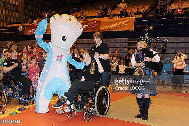 In this handout image provided by LOCOG, Official Paralympic mascot Mandeville with Chris Jacquin and his mum Mandy McDiarmid holding the Scottish...