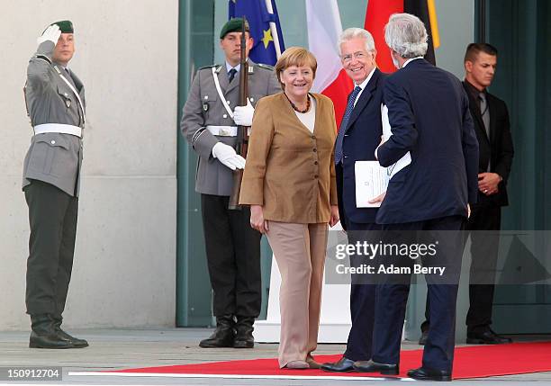 German Chancellor Angela Merkel greets Italian Prime Minister Mario Monti as arrives for a meeting with her at the German federal Chancellory on...