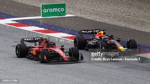 Max Verstappen of the Netherlands driving the Oracle Red Bull Racing RB19 and Carlos Sainz of Spain driving the Ferrari SF-23 battle for track...