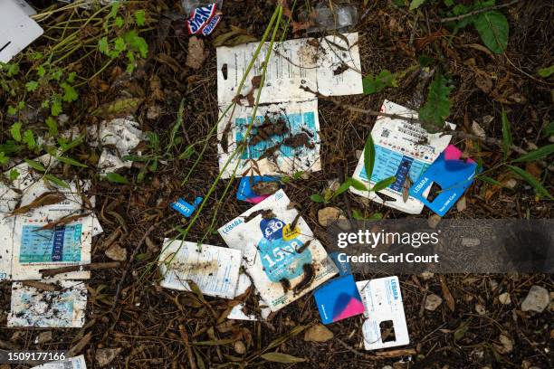 Discarded SIM card packets lie on the ground next to the River Roding on July 6, 2023 in London, England. More than three quarters of England's...