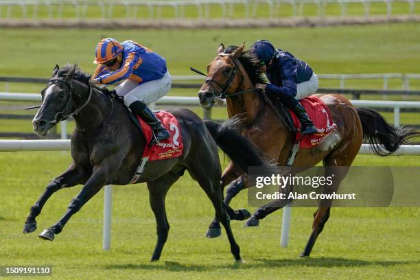 Ryan Moore riding Auguste Rodin win The Dubai Duty Free Irish Derby from Adelaide and Seamie Heffernan at Curragh Racecourse on July 02, 2023 in...