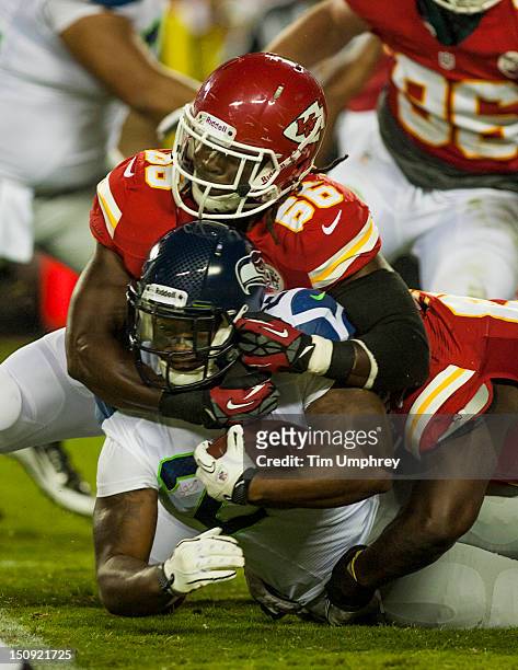 Running back Kregg Lumpkin of the Seattle Seahawks is tackled by linebacker Leon Williams of the Kansas City Chiefs in a game at Arrowhead Stadium on...