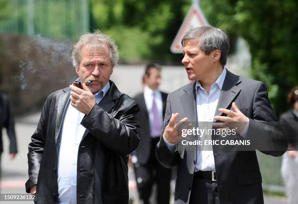 Commissioner for Agriculture and Rural Development, Romania's Dacian Ciolos , talks to Green Ecology party member Jose Bove after visiting a...